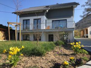 a house with flowers in front of it at Ferienwohnung Gluiber in Beuren