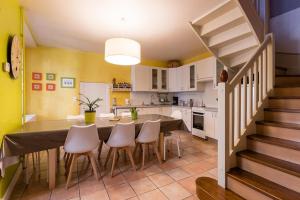 a kitchen and dining room with a table and chairs at Cocon Familial - Gîte De Charme in Die