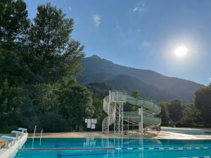 a water slide in a swimming pool at Cocon Familial - Gîte De Charme in Die