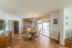 a kitchen and dining room with a table and chairs at Villa Arena Blanca in Sant Lluis
