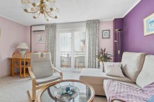 a living room with a couch and a glass table at Sanpolicarpo in Torrevieja