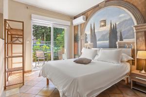 a bedroom with a large bed and a large window at L'Escale Au Soleil in Saint-Aygulf +35 photos
