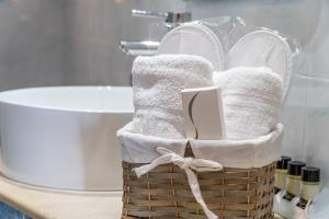 a basket of towels on a counter in a bathroom at Spyridoula Studio 2 in Paleokastritsa +16 photos