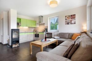 a living room with a couch and a table at Ferienhaus Seestern in Dranske