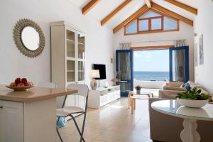 a kitchen and living room with a view of the ocean at La Mariana in Punta Mujeres