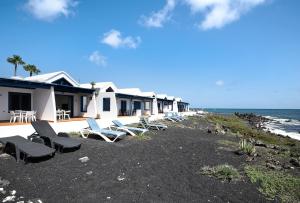 a group of beach chairs and a row of houses at La Mariana in Punta Mujeres