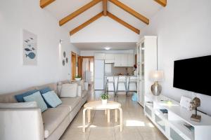 a living room with a couch and a table at La Mariana in Punta Mujeres +18 photos