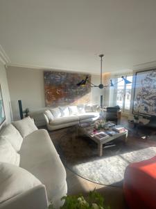 a living room with a white couch and a coffee table at 51 Hotel Apartment in London