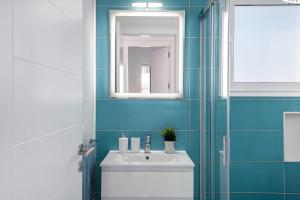 a bathroom with a sink and a mirror at Ocean 1 in La Santa +14 photos