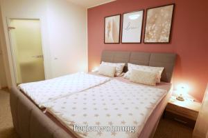 a bedroom with a large bed with orange walls at Pension Haus Linden in Winterberg