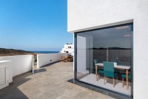 a patio with a table and chairs on a balcony at Ocean 1 in La Santa