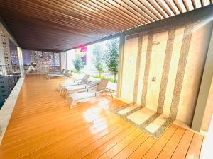 a large room with chairs and a wooden floor at Chamber Haven KLCC in Kuala Lumpur
