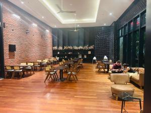 a restaurant with tables and chairs and a brick wall at Chamber Haven KLCC in Kuala Lumpur