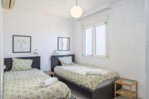 a bedroom with two beds and a window at Balcon de Benalmadena Ocean Views in Benalmádena +21 photos