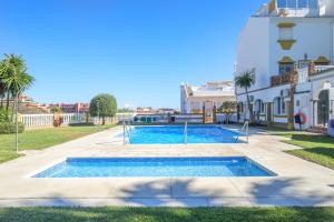 a swimming pool in front of a building at Balcon de Benalmadena Ocean Views in Benalmádena