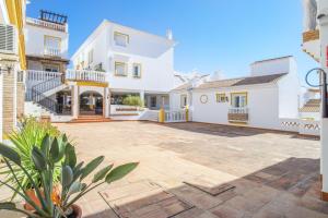 a large courtyard in a house with white buildings at Balcon de Benalmadena Ocean Views in Benalmádena