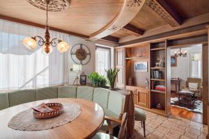 a living room with a table and a couch at Dimora Il Feudo - Predazzo in Predazzo