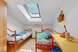 a bedroom with a bed and a desk and a table at Mansarda di Ponente in Caorle