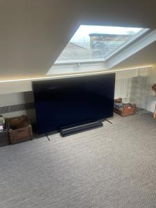 a large flat screen tv sitting in a living room at 51 Hotel Apartment in London