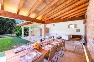 a dining room with a long table with chairs at Can Estela in Sencelles