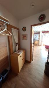 a living room with a wooden floor and a room at Ferienwohnung Älple im Sonnenpark in Bad Hindelang +3 photos
