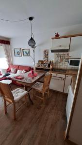 a kitchen and a living room with a table and chairs at Ferienwohnung Älple im Sonnenpark in Bad Hindelang