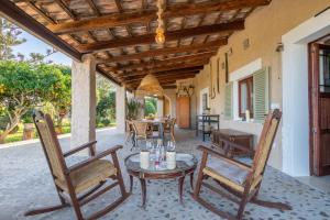 a patio with chairs and a table and a tableablish at Finca Cas Forner in Islas Baleares