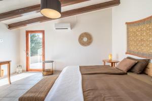 a bedroom with a large bed and a window at Finca Cas Forner in Islas Baleares +28 photos