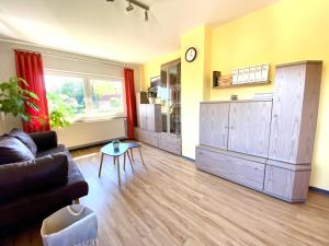 a living room with a couch and a table at Ferienwohnung Alraftsblick in Waldeck +15 photos