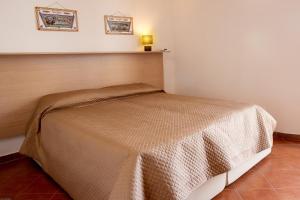 a small bed in a corner of a room at Casa Atena in Motta D'affermo