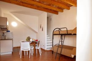 a room with a table and chairs and a bunk bed at Casa Atena in Motta D'affermo