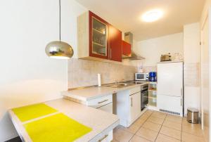 a kitchen with a sink and a white refrigerator at Ferienwohnung Manns in Bettnau +11 photos