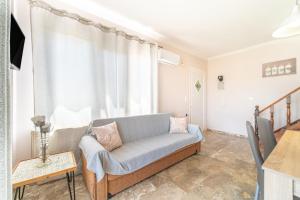 a living room with a couch and a window at Villa Logas in Peroulades