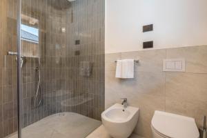 a bathroom with a shower and a toilet and a sink at Les Ciases Chalets Dolomites Apt 4 in San Vigilio Di Marebbe +35 photos