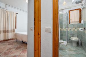 a bathroom with a toilet and a shower at Holiday house li Piri in San Teodoro +18 photos