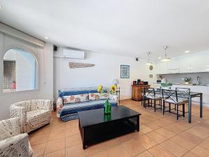 a living room with a couch and a table at Holiday Home Salins by Interhome in Empuriabrava