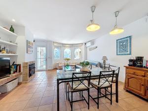 a kitchen and living room with a table and chairs at Holiday Home Salins by Interhome in Empuriabrava