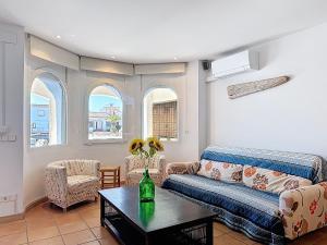 a living room with a couch and a table at Holiday Home Salins by Interhome in Empuriabrava +32 photos