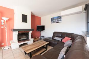 a living room with a couch and a fireplace at Gite d'Ayzi in Ouzous