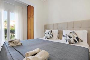 a bedroom with a large bed with towels on it at Olympia Holiday Home in Zakynthos +18 photos