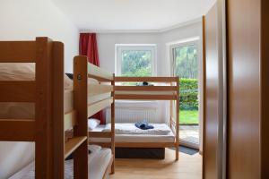 a room with three bunk beds and a window at Apartment Tux in Mayrhofen