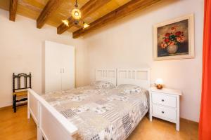a bedroom with a bed and a painting on the wall at Can Company in Campanet +31 photos