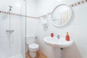 a bathroom with a toilet and a sink and a mirror at Antiga escola de Molinell in Culla +17 photos