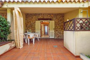 a patio with a table and chairs and a building at Residence Asfodeli E4 in San Teodoro