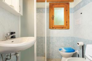 a bathroom with a sink and a toilet and a mirror at Residence Asfodeli E4 in San Teodoro +17 photos