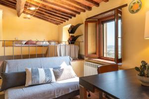 a living room with a couch and a table at Small Rustic Apartment in Scrofiano