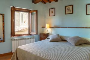 a bedroom with a large bed with a window at Small Rustic Apartment in Scrofiano