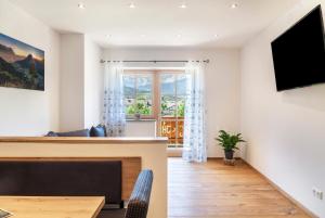 a living room with a fireplace and a television at Ferienwohnung Vrenal in Farchant