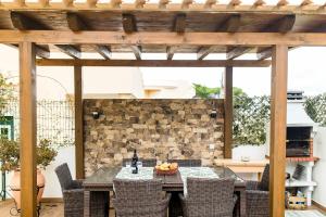 an outdoor patio with a table and chairs at Laguna Formosa in Faro