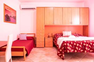 a bedroom with two beds and a cabinet at B&B Pedruzza in Alghero